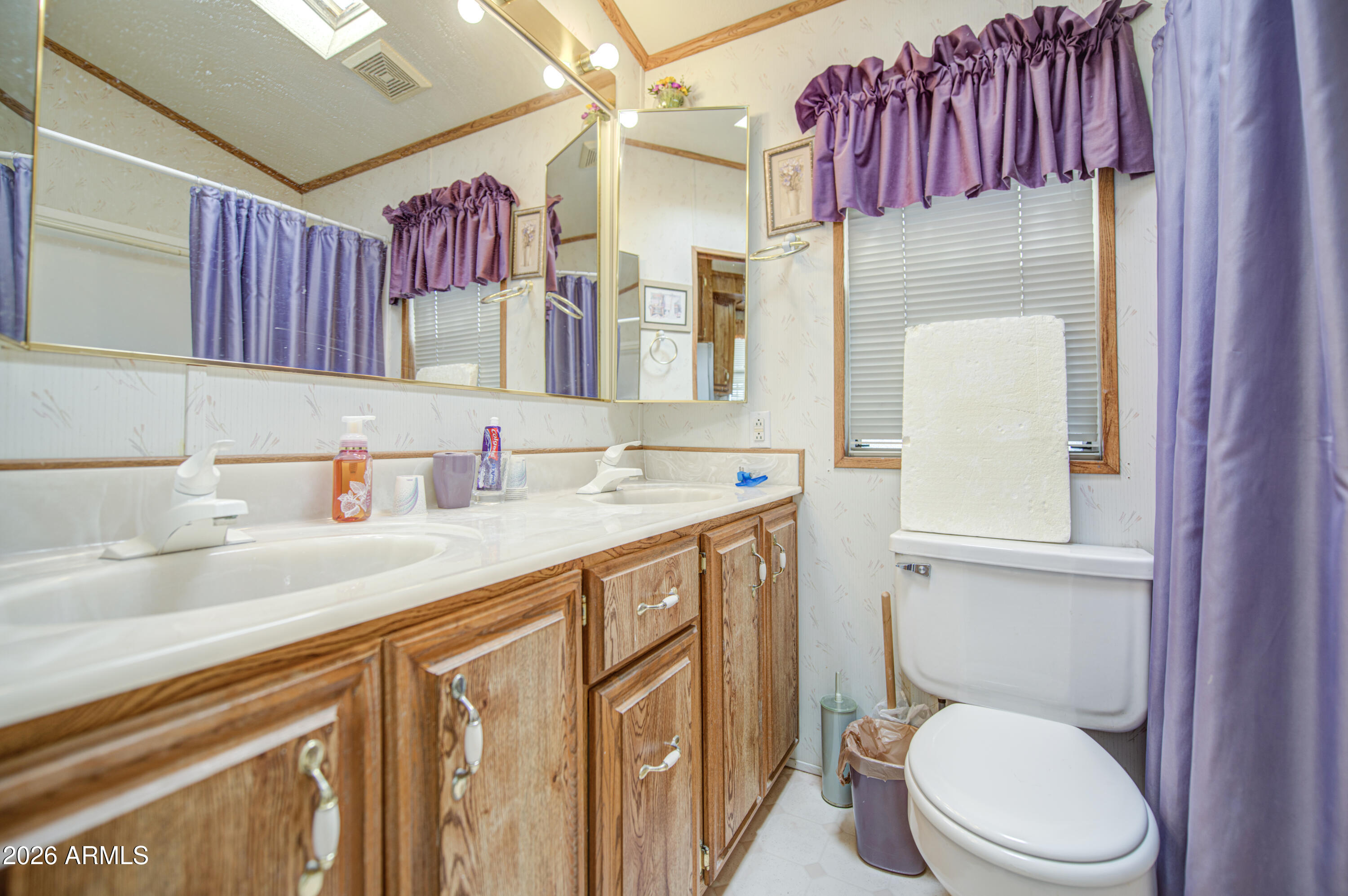 7750 East Broadway Road, Unit 512 Mesa, AZ 85208 - Photo 18 of 32 a bathroom with a granite countertop toilet sink and mirror