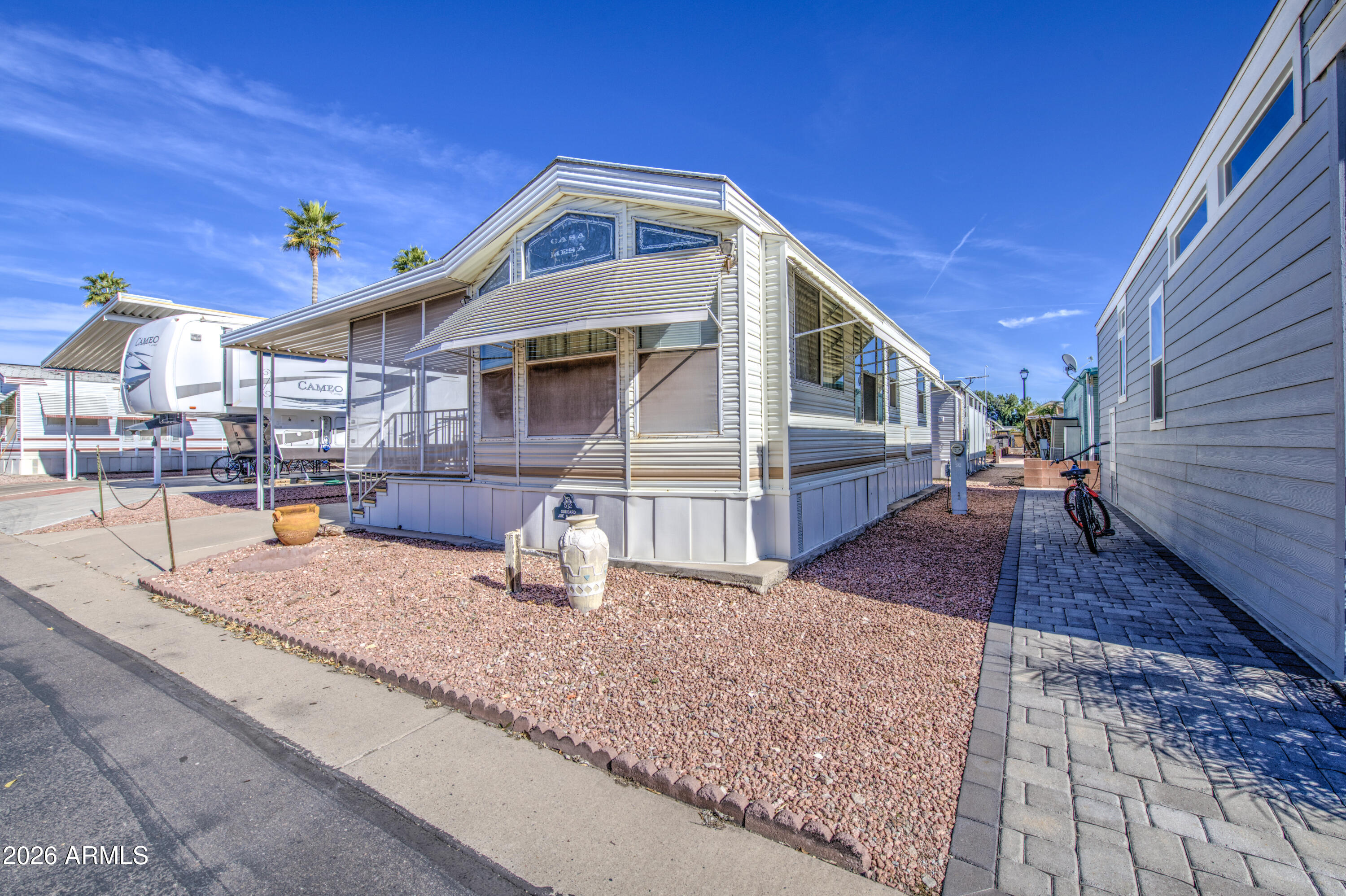 7750 East Broadway Road, Unit 512 Mesa, AZ 85208 - Photo 3 of 32 a front view of a house with swimming pool