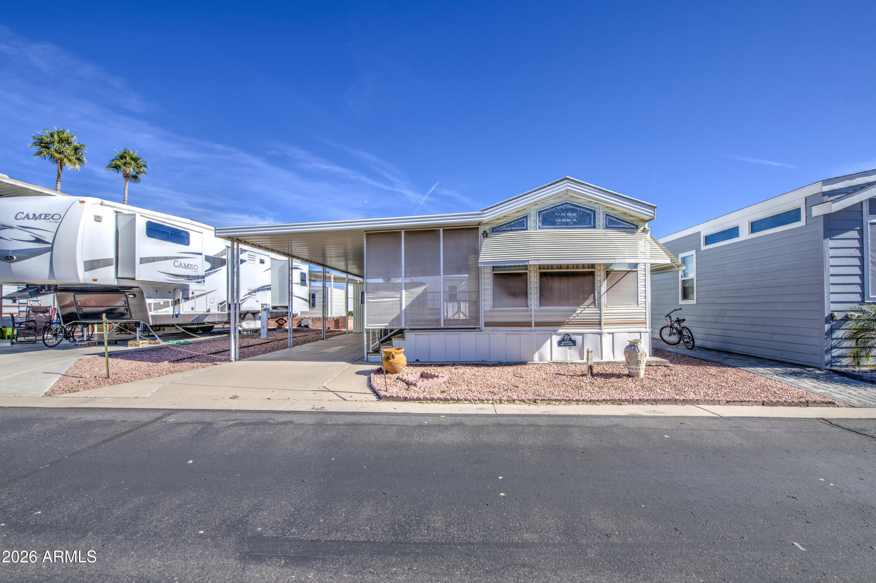 7750 East Broadway Road, Unit 512 Mesa, AZ 85208 - Photo 4 of 32 a front view of a house with a patio