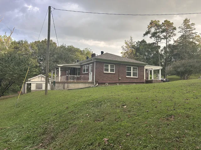 a view of a room with wooden floor and windows