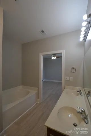 a bathroom with a tub and shower