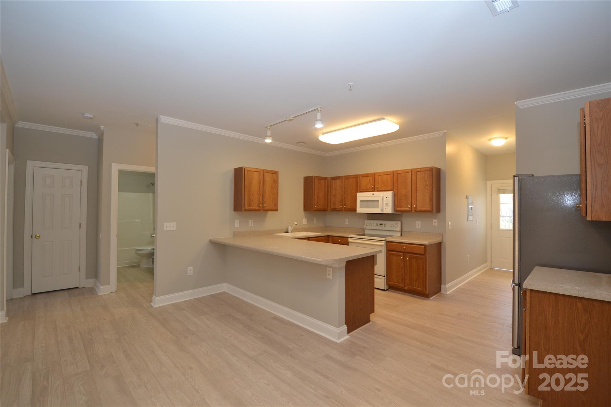 19820 Feriba Place Cornelius, NC 28031 - Photo 5 of 16 a kitchen with a sink and a refrigerator