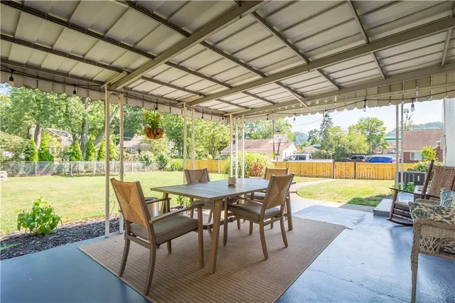 a view of a patio with a table chairs and a patio