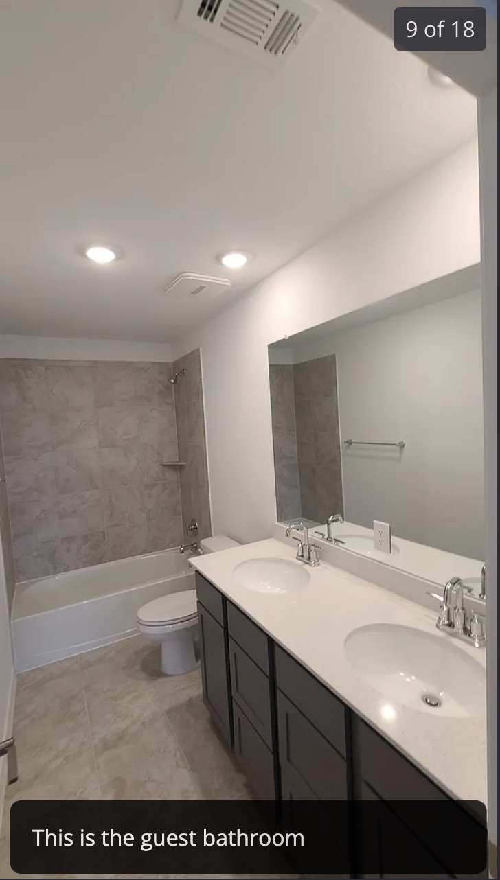 561 Pepperbark Loop Buda, TX 78610 - Photo 11 of 15 Bathroom featuring shower / bath combination and double vanity