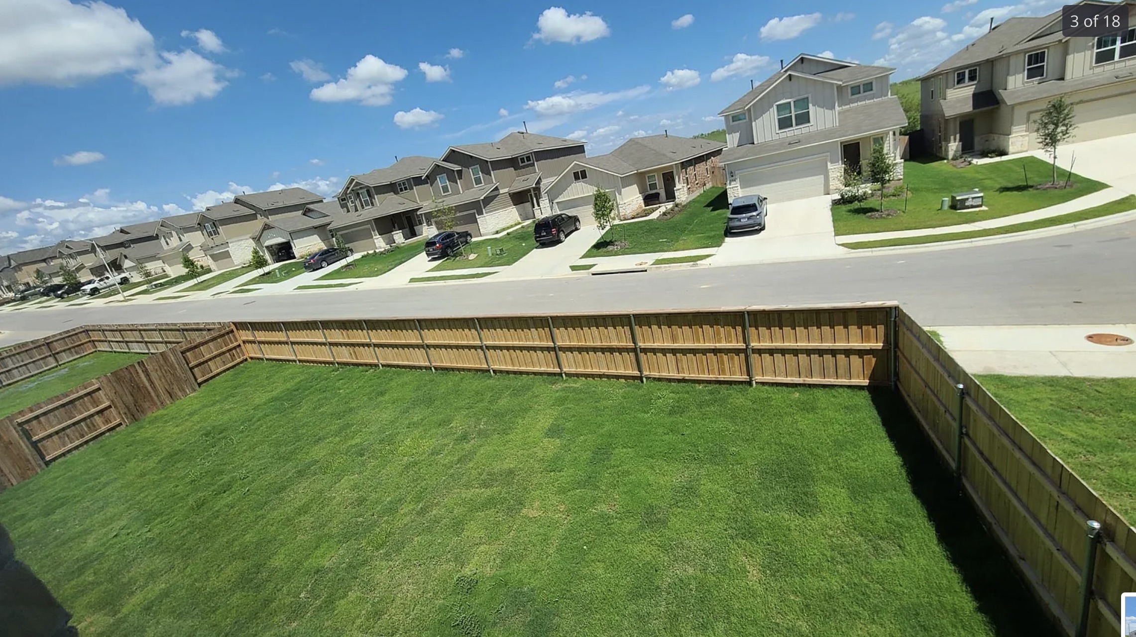 561 Pepperbark Loop Buda, TX 78610 - Photo 3 of 15 View of green lawn featuring a residential view and a garage