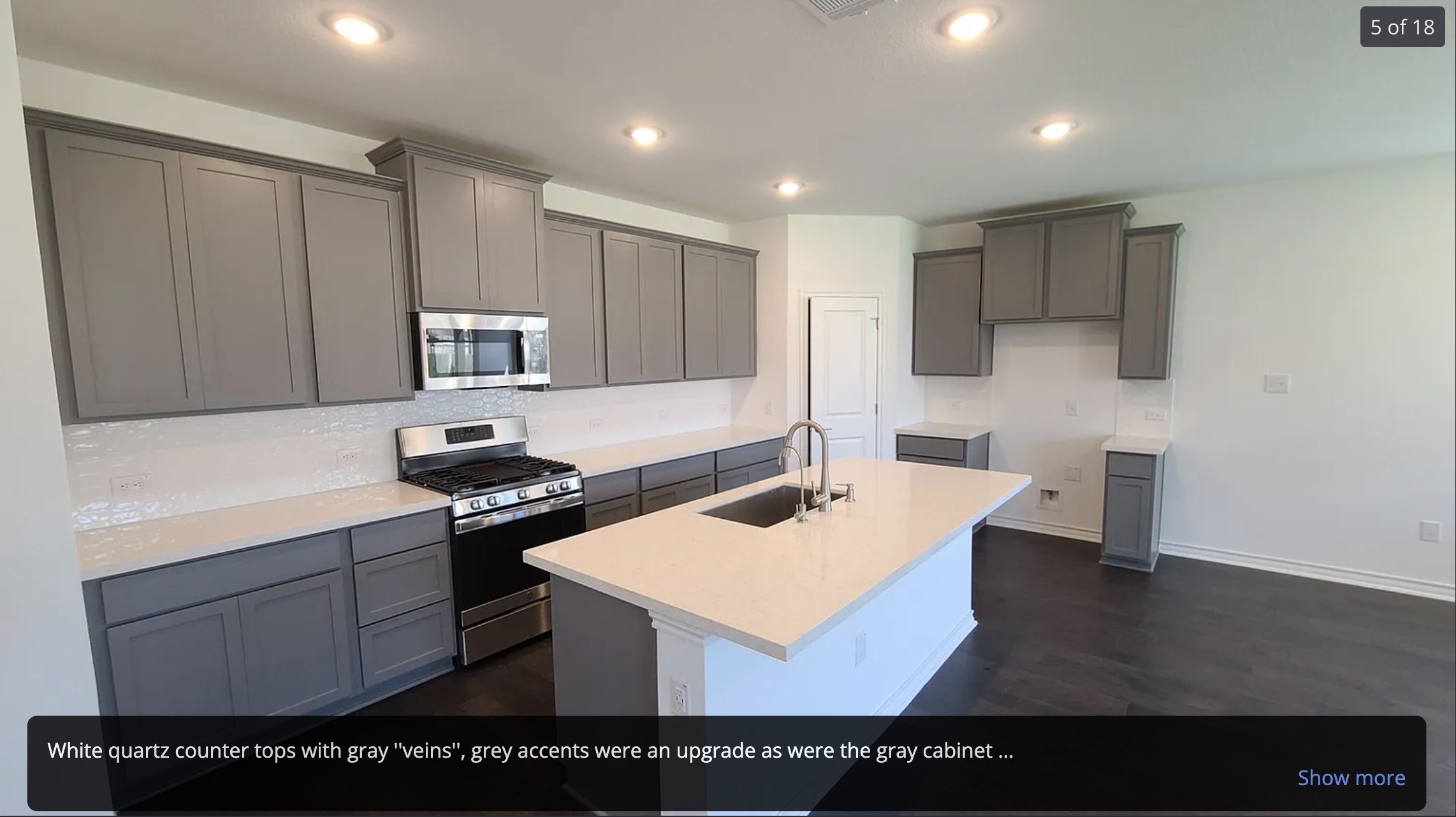 561 Pepperbark Loop Buda, TX 78610 - Photo 4 of 15 Kitchen featuring stainless steel appliances, a kitchen island with sink, gray cabinetry, dark wood-style flooring, and recessed lighting