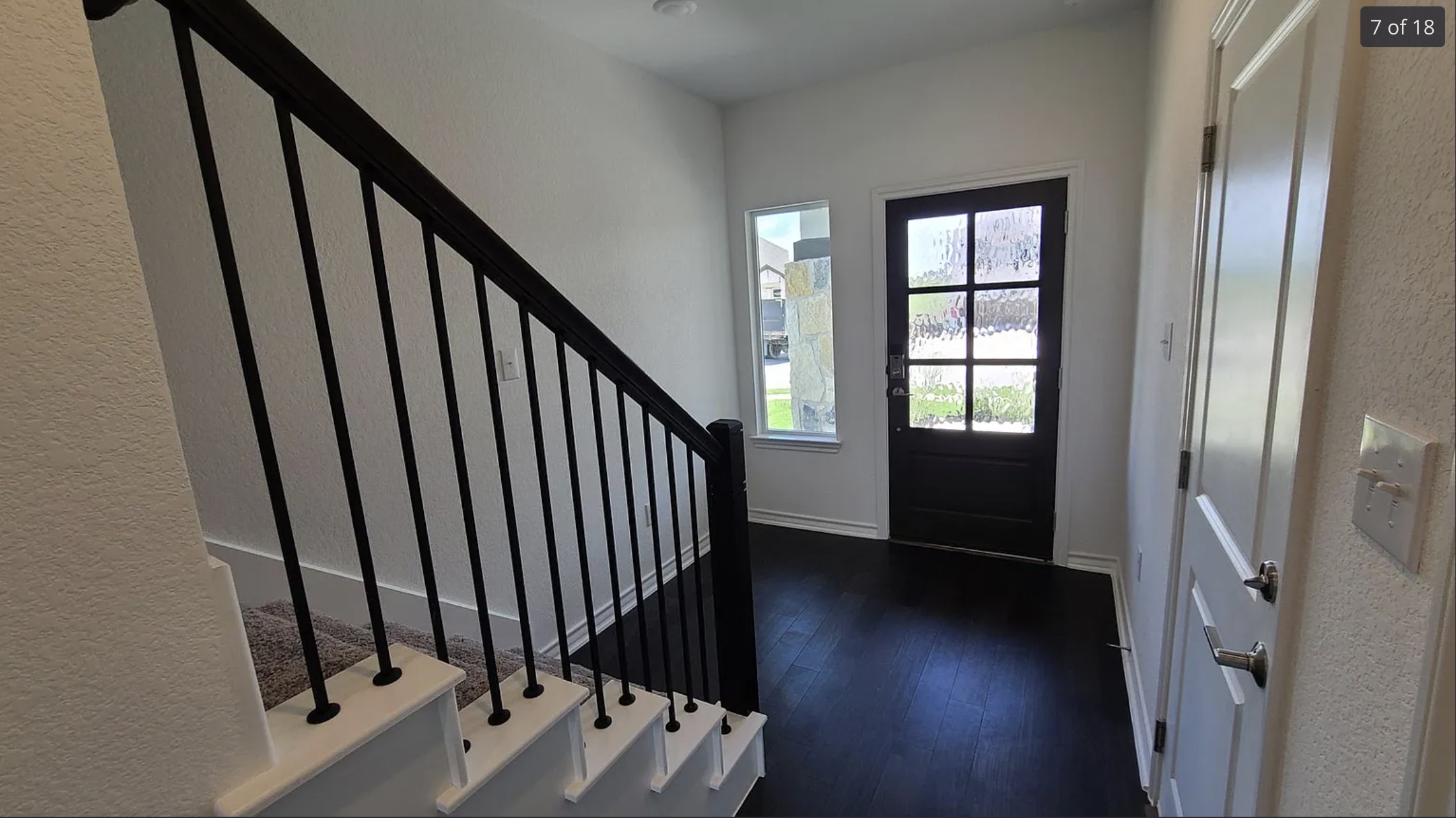 561 Pepperbark Loop Buda, TX 78610 - Photo 5 of 15 Entrance foyer featuring a textured wall and dark wood-style flooring