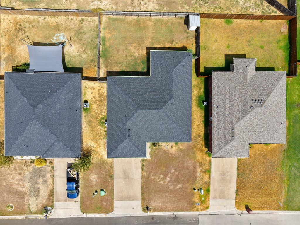 10620 Granada Drive Waco, TX 76708 - Photo 36 of 38 Asphalt shingle roofing, concrete driveway, fenced perimeter, and expansive yard