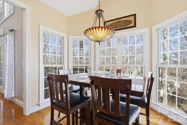 a view of a dining room with furniture wooden floor and chandelier