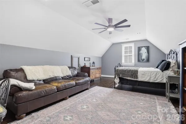 a living room with furniture a ceiling fan and a rug