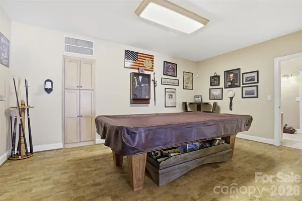 a bed room with a bed and paintings on the wall