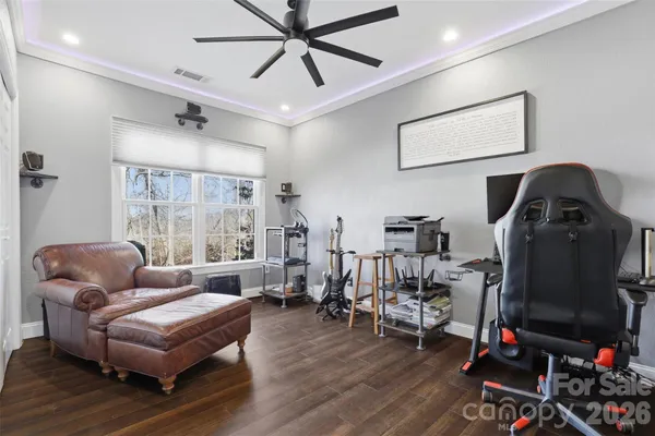a living room with furniture a ceiling fan and a window