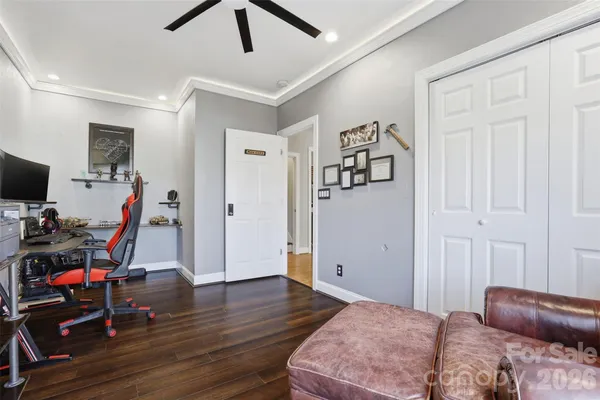 a bedroom with furniture and a gym equipment