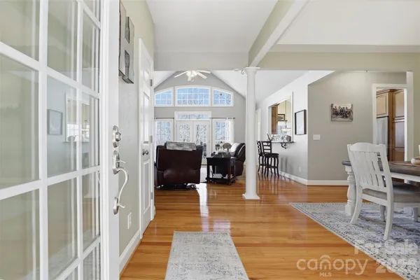 a living room with furniture a clock and a view of living room