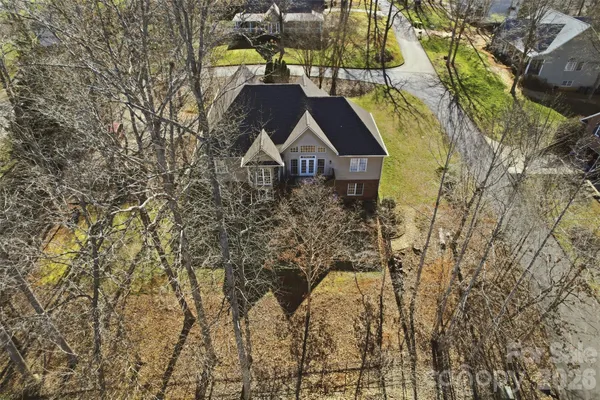 an aerial view of residential houses with outdoor space and mountain view