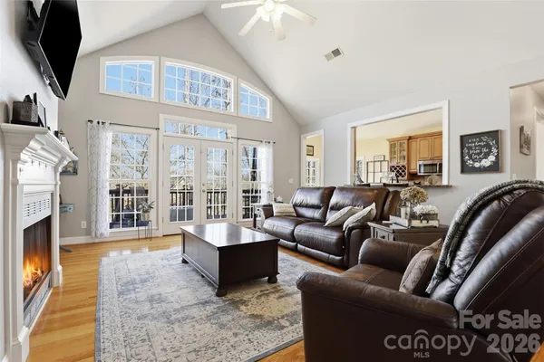 a living room with furniture fireplace and flat screen tv