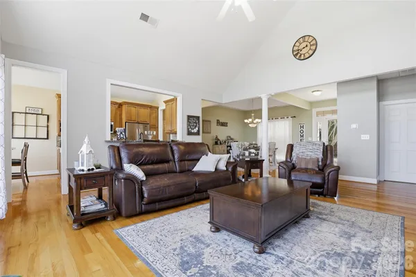 a living room with furniture and a wooden floor