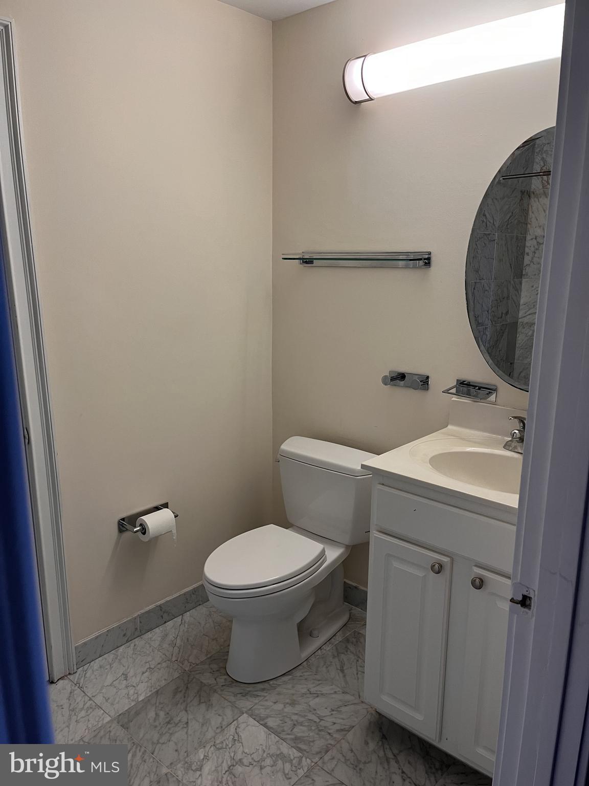 1500 Chestnut Street, Unit 15I Philadelphia, PA 19102 - Photo 12 of 18 a bathroom with a toilet a sink and mirror