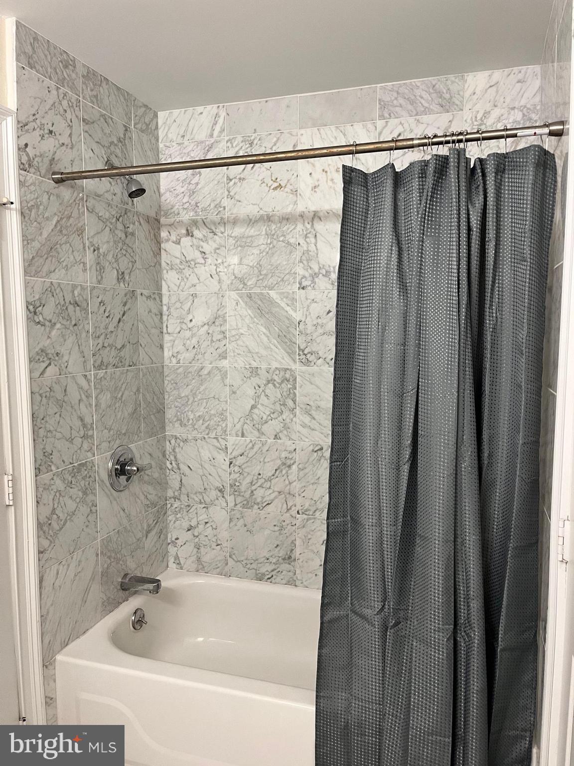 1500 Chestnut Street, Unit 15I Philadelphia, PA 19102 - Photo 15 of 18 a bathroom with a shower and a tub