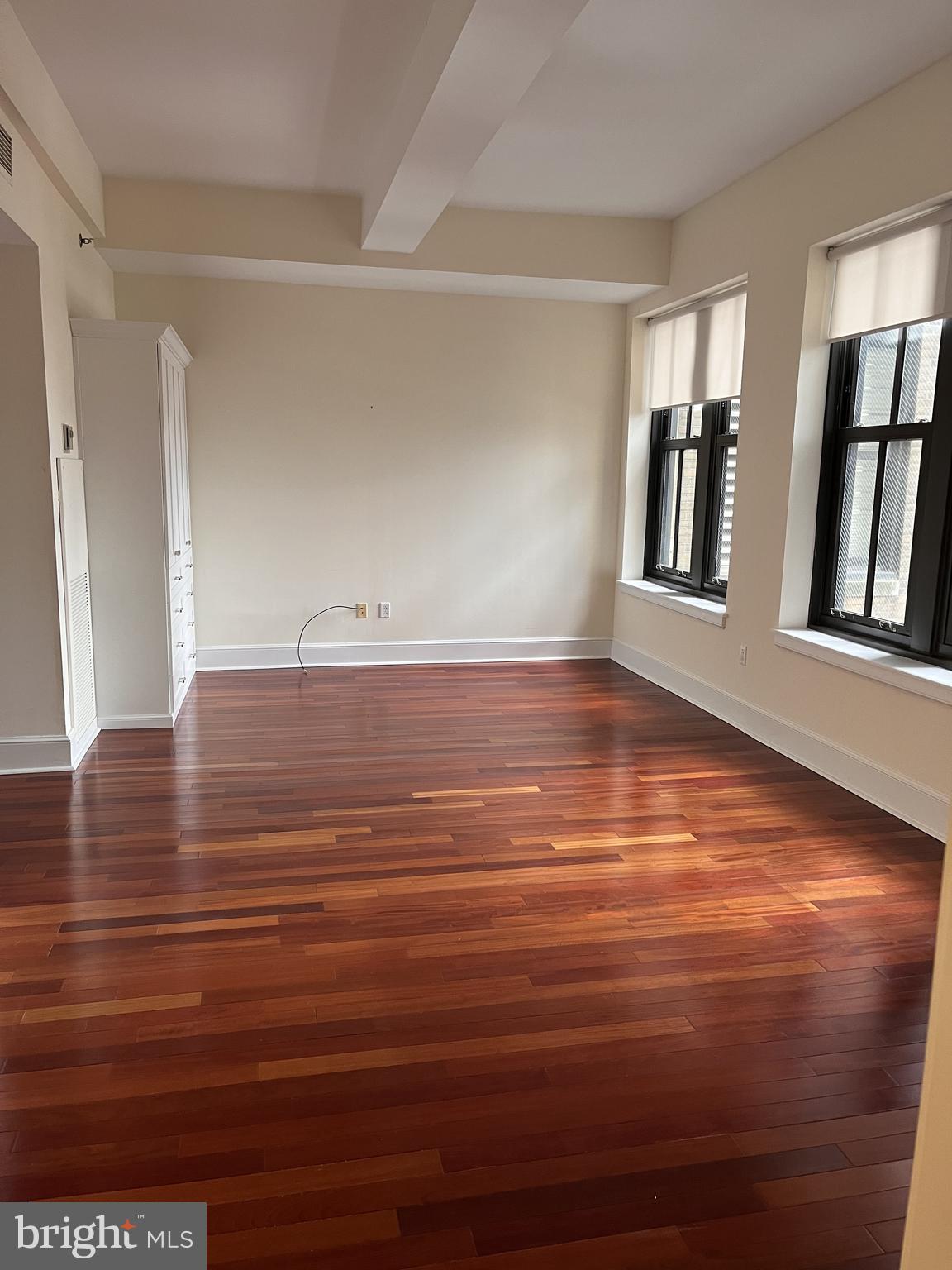 1500 Chestnut Street, Unit 15I Philadelphia, PA 19102 - Photo 4 of 18 a view of room with window and wooden floor