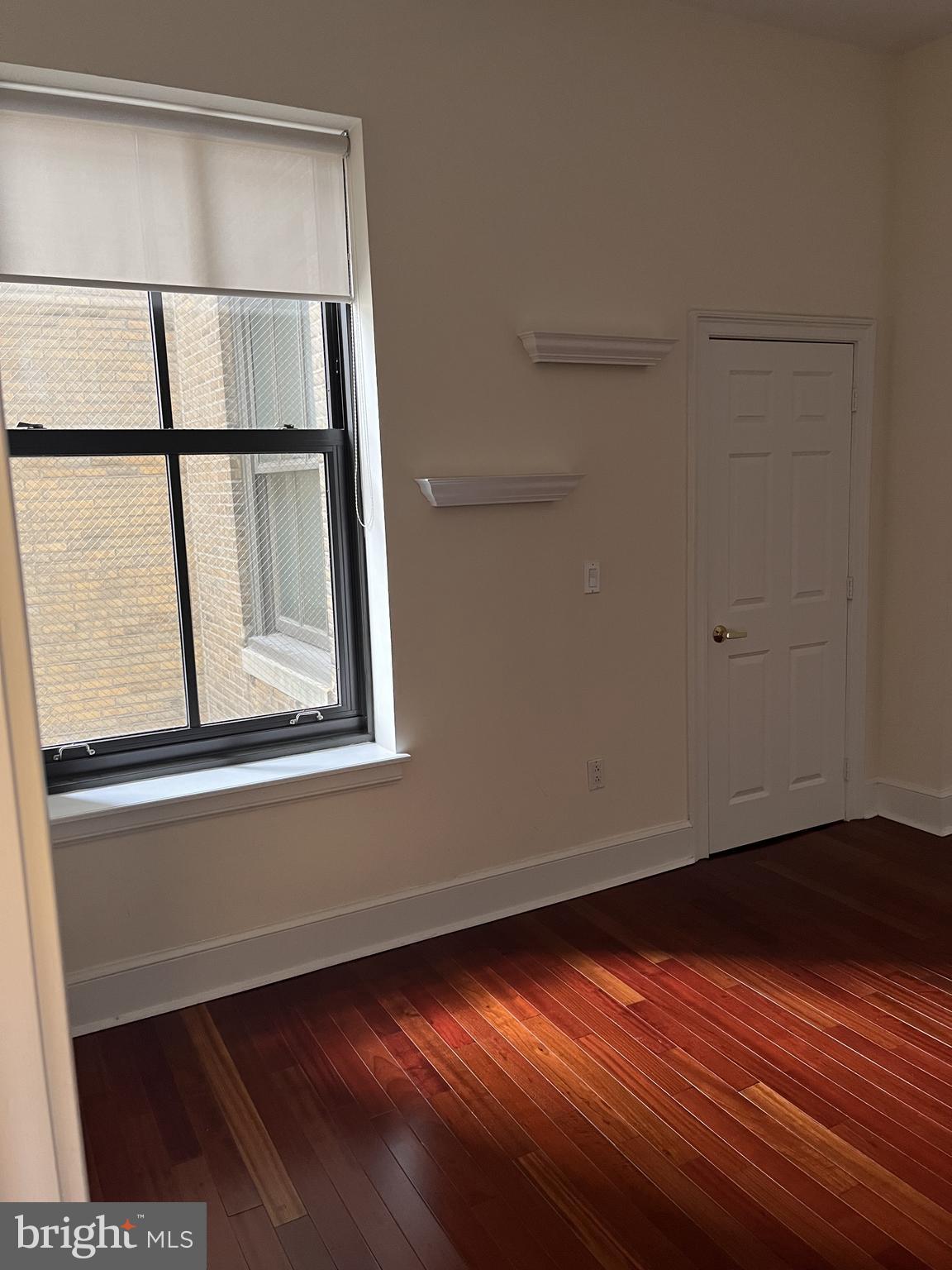 1500 Chestnut Street, Unit 15I Philadelphia, PA 19102 - Photo 8 of 18 a view of empty room with window and wooden floor