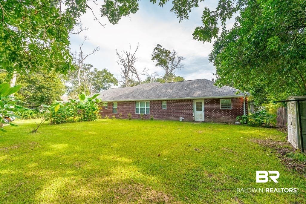 12641 Pecan Street Grand Bay, AL 36541 - Photo 21 of 23 Rear view of property featuring a yard