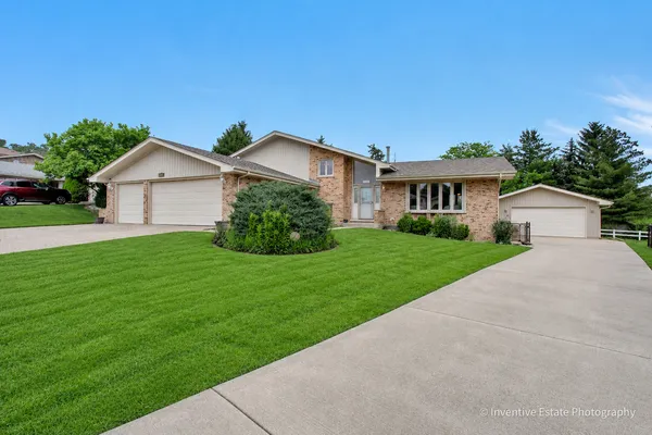 a front view of house with yard and green space