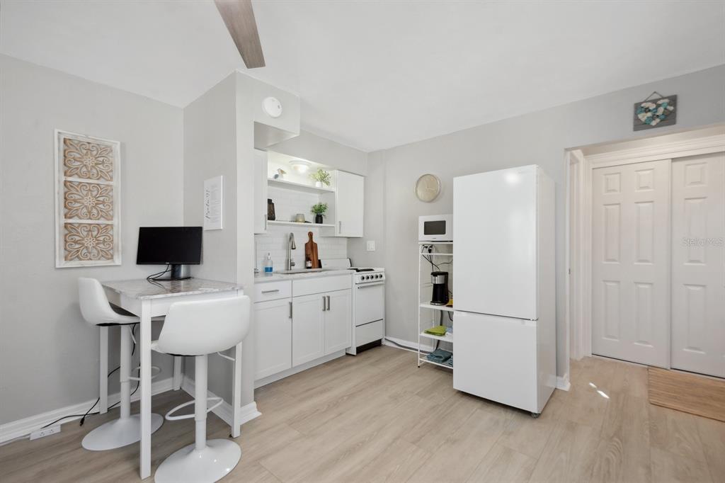 1214 Bay Pine Boulevard Indian Rocks Beach, FL 33785 - Photo 25 of 49 a view of a workspace with furniture and wooden floor