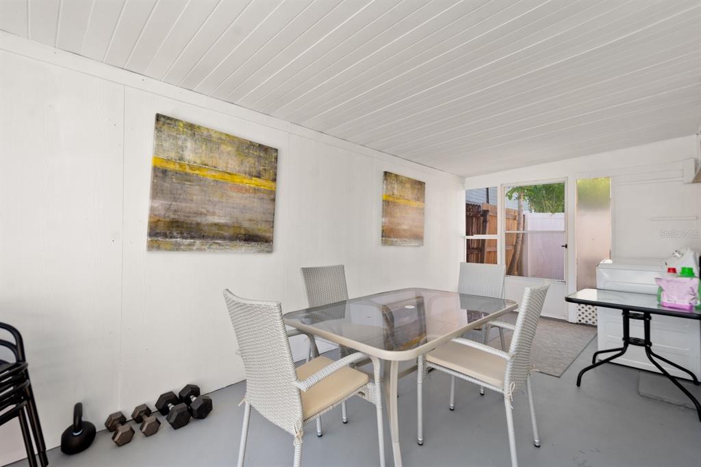 1214 Bay Pine Boulevard Indian Rocks Beach, FL 33785 - Photo 28 of 49 a view of a dining room with furniture and wooden floor