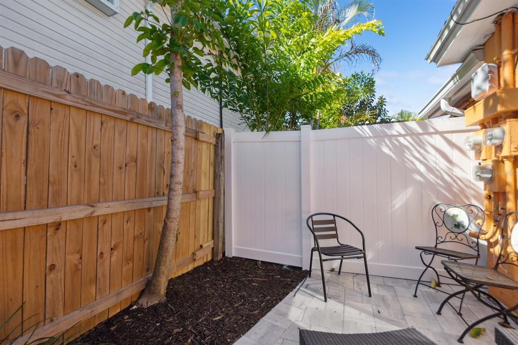 1214 Bay Pine Boulevard Indian Rocks Beach, FL 33785 - Photo 31 of 49 a backyard of a house with table and chairs