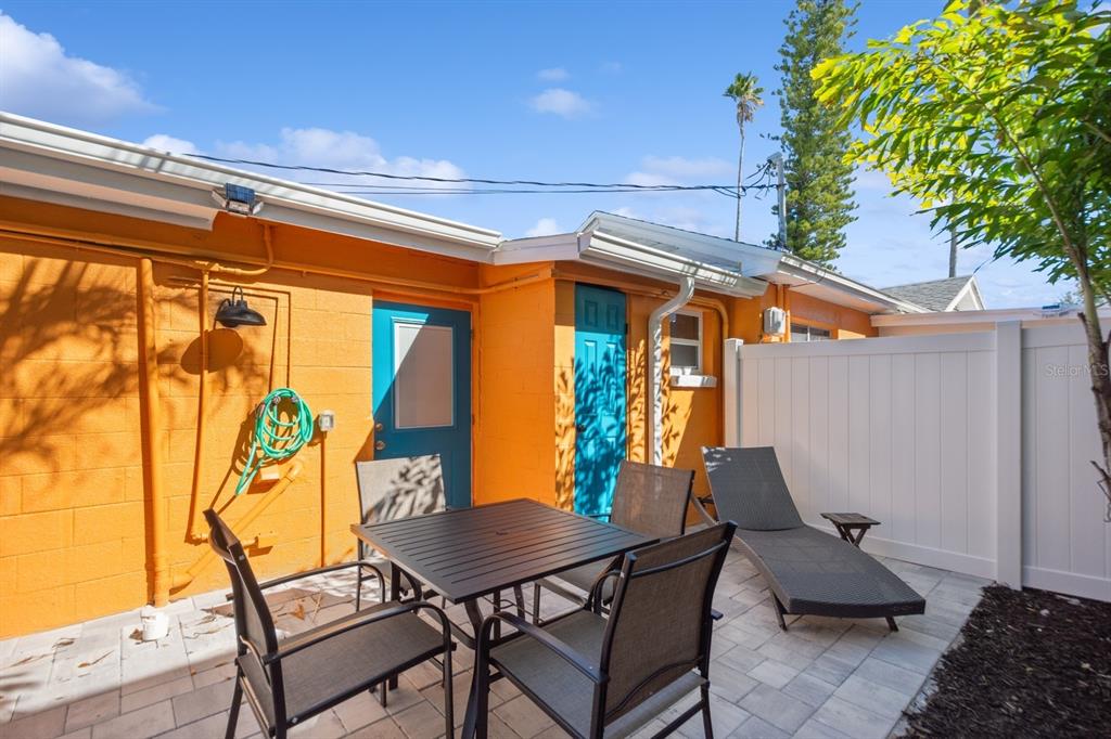 1214 Bay Pine Boulevard Indian Rocks Beach, FL 33785 - Photo 34 of 49 a view of a patio with a table and chairs and potted plants