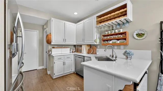 a kitchen with a sink cabinets and stainless steel appliances