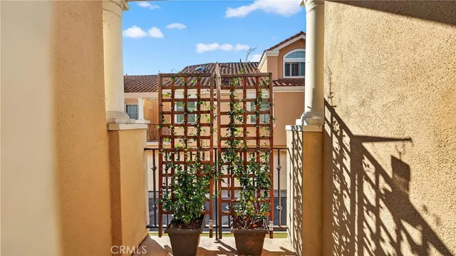 a view of balcony with wooden floor and a potted plant