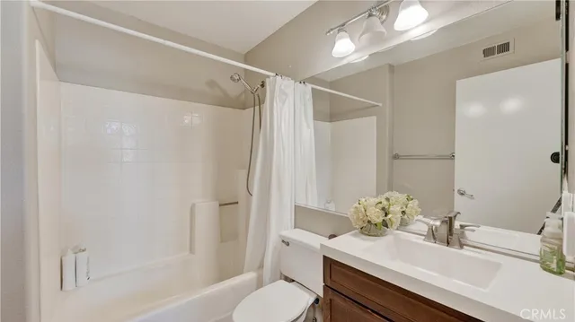 a bathroom with a sink toilet tub and shower
