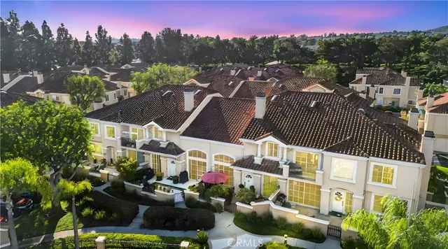 an aerial view of residential houses with outdoor space and river