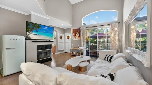 a living room with furniture a fireplace and a flat screen tv