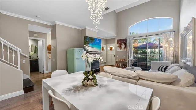 a living room with furniture fireplace and a large window