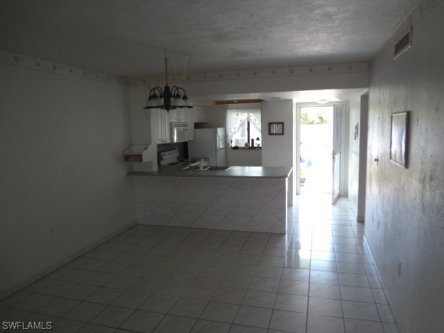 25225 Rampart Boulevard Punta Gorda, FL 33983 - Photo 5 of 7 a view of a room with wooden floor and windows