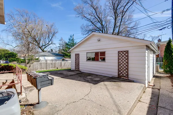 a backyard of a house with barbeque oven