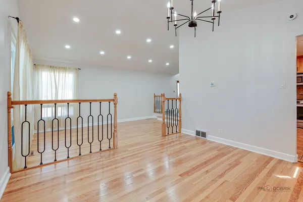 a kitchen with granite countertop stainless steel appliances a refrigerator stove top oven and sink