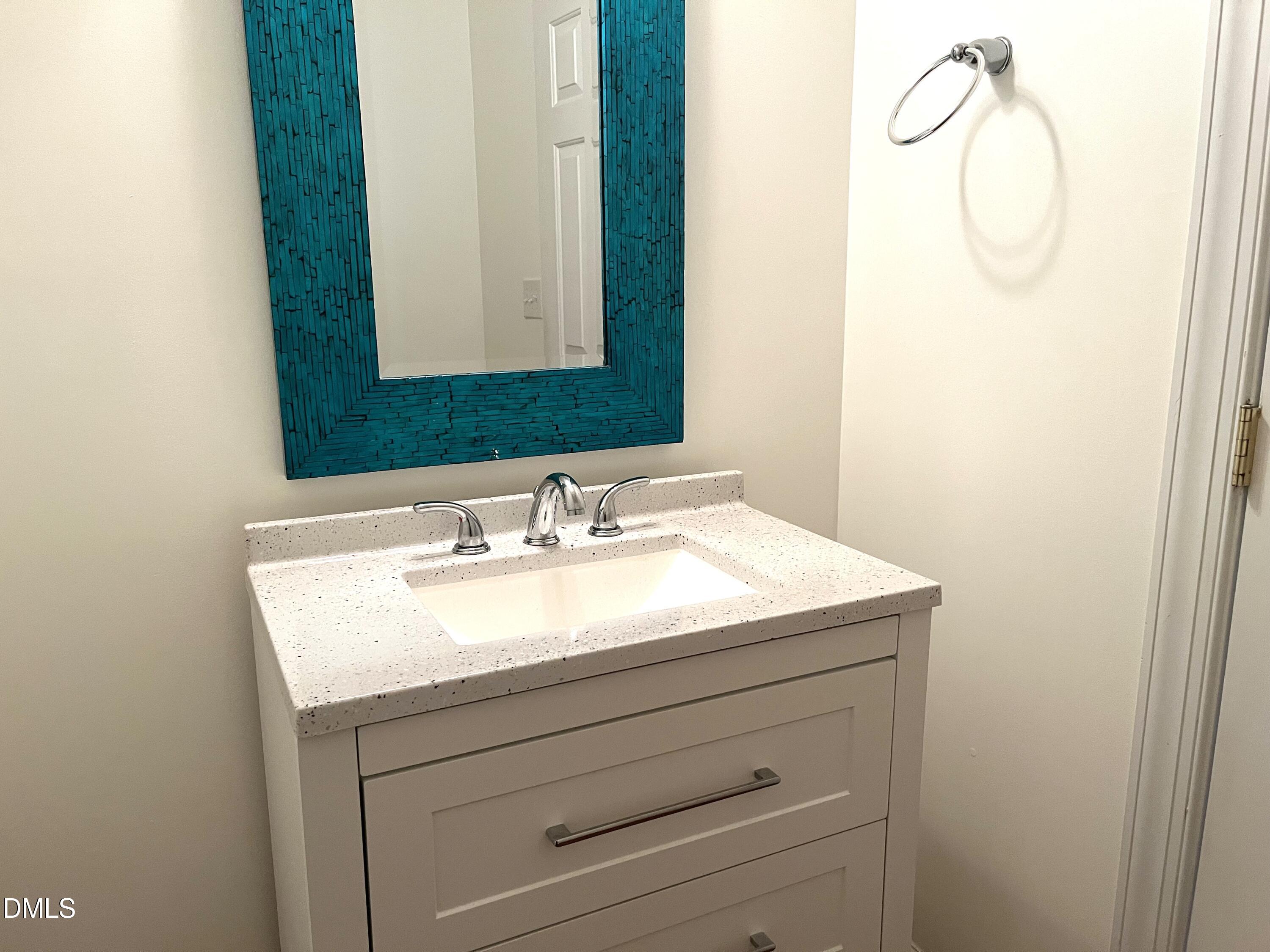 5206 Rio Grande Drive Raleigh, NC 27616 - Photo 32 of 37 a bathroom with a sink and a mirror