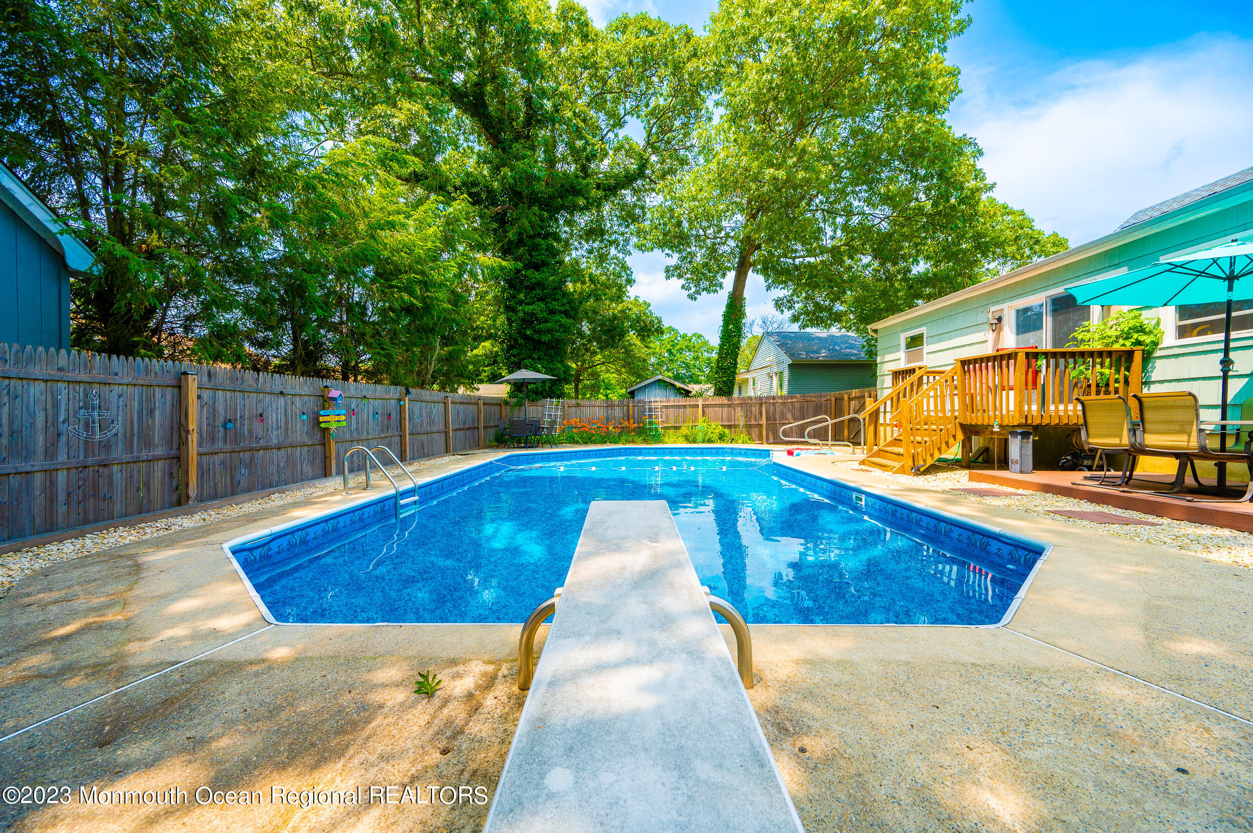 30 London Road Brick, NJ 08723 - Photo 44 of 64 a view of swimming pool with sitting area and trees in the background