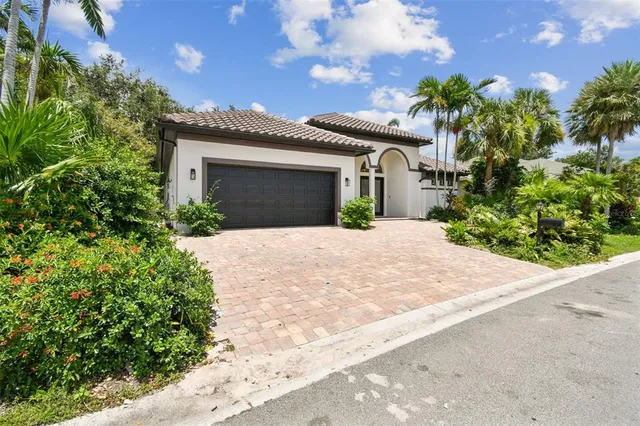 a front view of a house with a yard and a garage