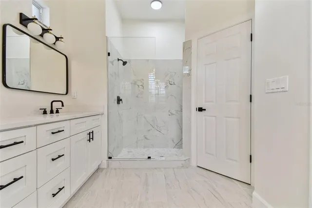 a view of a house with a yard and potted plants