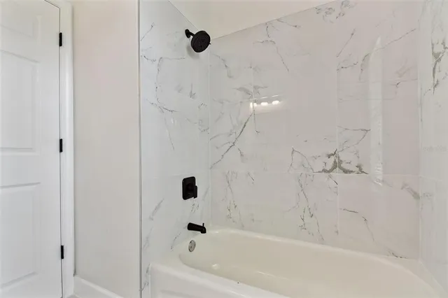 an aerial view of residential houses with outdoor space and swimming pool