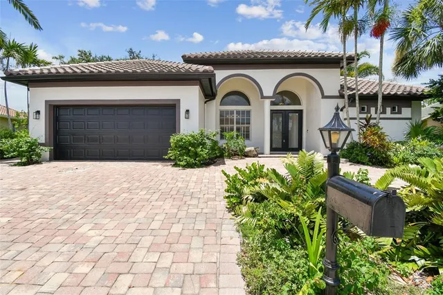 a front view of a house with a garden