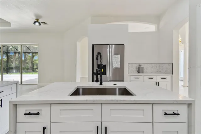 a kitchen with stainless steel appliances granite countertop a stove top oven a sink and dishwasher
