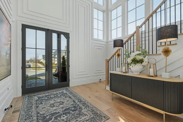 a living room with furniture a flat screen tv and a floor to ceiling window