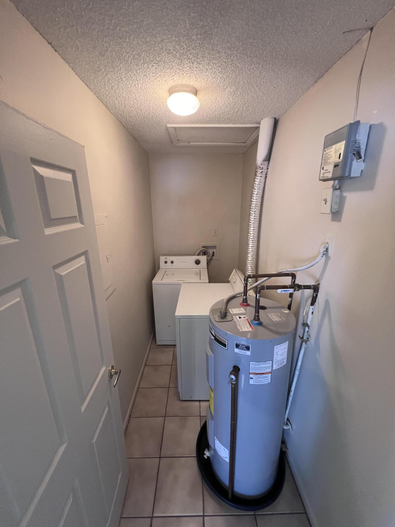 1050 North Fiske Boulevard, Unit 701 Cocoa, FL 32922 - Photo 5 of 5 a room with a sink washer and dryer