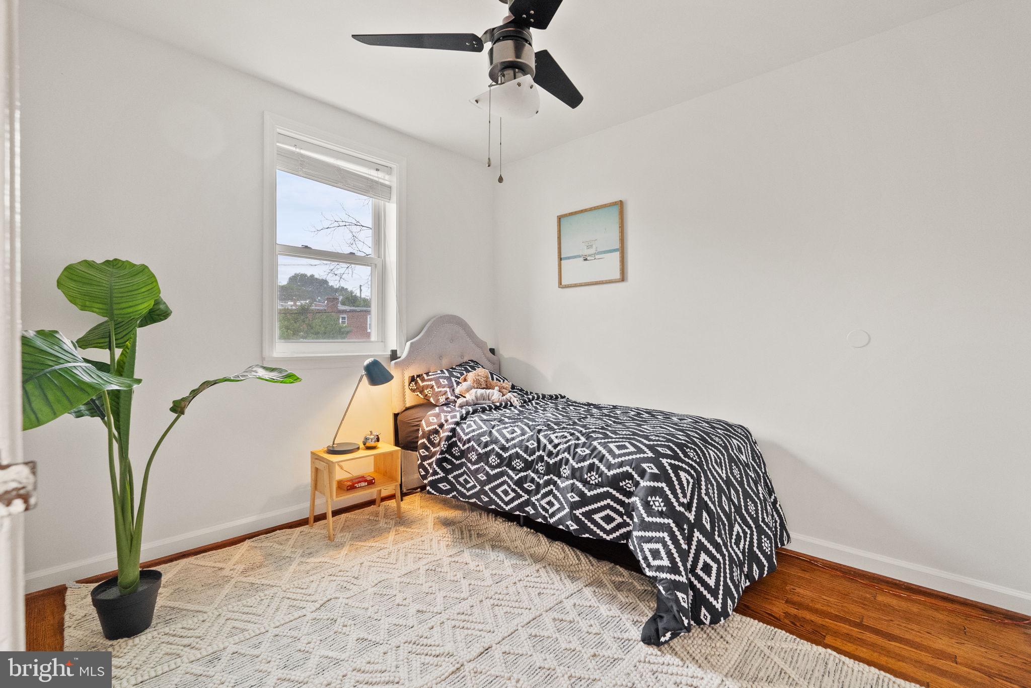 518 Riggs Road Northeast Washington, DC 20011 - Photo 11 of 18 a bedroom with a bed and a window